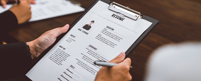 person filling out a resume